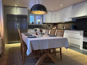 cocina con mesa y mantel blanco en House in Åre Björnen ski-in ski-out, en Åre