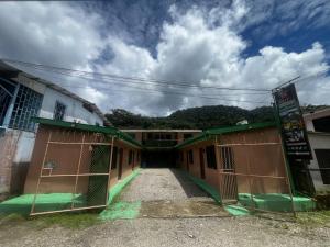 a group of buildings with their gates open at Cabinas Golfito in Golfito