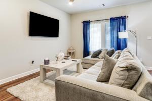 a living room with a couch and a tv at Explore Baton Rouge and LSU Family Home with Yard in Baker