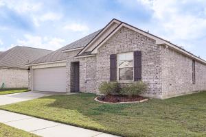 a brick house with a garage at Explore Baton Rouge and LSU Family Home with Yard in Baker