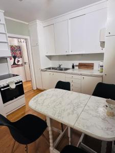 a kitchen with a table and chairs in a room at Strandveien apartment in Narvik