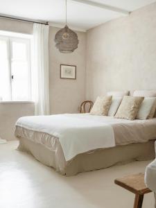 ChampignollesTraditional Apartment In The Heart Of Burgundy的卧室里有一张大床，床单和枕头都是白色的