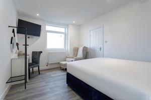 Ένα ή περισσότερα κρεβάτια σε δωμάτιο στο Savoy 5