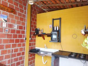 a kitchen with a sink and a brick wall at Chalé 02 Cantinho do Céu- Santo Amaro do MA in Santo Amaro +11 photos