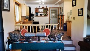 a living room with a couch with pillows at Yellow Dog Lodge, Inc. in Camlaren