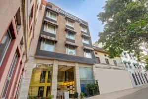 an apartment building with a large window at Hotel Ambience in New Delhi