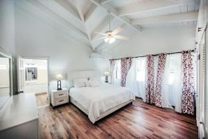 una camera da letto con un letto e un ventilatore a soffitto di Stunning 4 bedroom villa a Saint John's