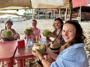 a group of women sitting at a table on the beach at Beachfront Paradise Boutique Hotel - Breeze Room ll in Playa Agua Blanca