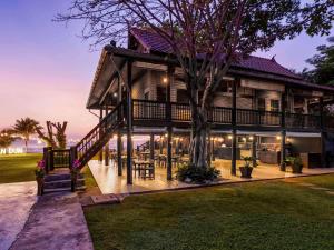 a house with a staircase leading up to it at Mövenpick Asara Resort & Spa Hua Hin in Hua Hin