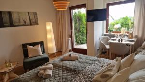a bedroom with a bed with two slippers on it at Cozy Schwarzwaldnest für 2! in Schönwald +11 photos