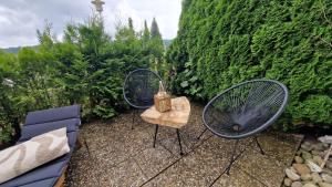 a patio with two blue chairs and a table at Cozy Schwarzwaldnest für 2! in Schönwald
