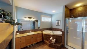 a bathroom with a tub and a sink and a shower at Sooke Harbour Penthouse in Sooke +67 photos