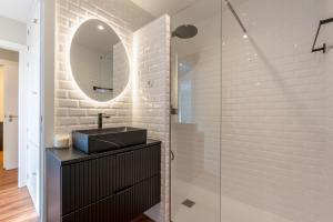 a bathroom with a sink and a mirror at Bright Beachside Flat with Terrace by HostWise in Matosinhos +36 photos