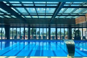 a large swimming pool with a large ceiling at The Grandeur Hotel in Batumi