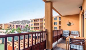 a balcony with two chairs and a table with a view at Relax & Enjoy - El Mocan - Palm Mar in Palm-Mar