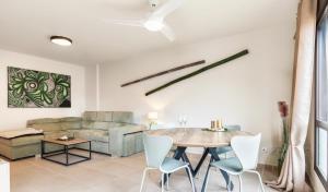 a living room with a table and a couch at Relax & Enjoy - El Mocan - Palm Mar in Palm-Mar