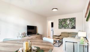 a living room with a couch and a table at Relax & Enjoy - El Mocan - Palm Mar in Palm-Mar