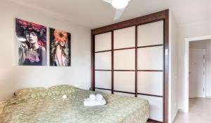 a bedroom with a bed and two posters on the wall at Relax & Enjoy - El Mocan - Palm Mar in Palm-Mar