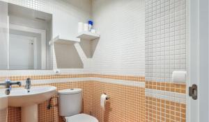 a bathroom with a toilet and a sink and a mirror at Relax & Enjoy - El Mocan - Palm Mar in Palm-Mar +7 photos