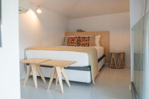 a bedroom with a bed and a wooden table at I Loft Porto in Porto