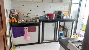 a kitchen with a sink and a dishwasher at Chambre Cosy Climatisé, Romantique et indépendante chez l'habitant in Tangier
