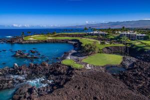 an aerial view of a golf course on the ocean at Mauna Lani Point in Waikoloa