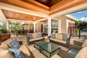 an outdoor living room with couches and a table at Mauna Lani Point in Waikoloa