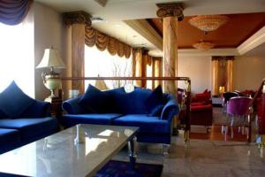 a living room with blue couches and a table at Cesar Palace Sousse in Sousse