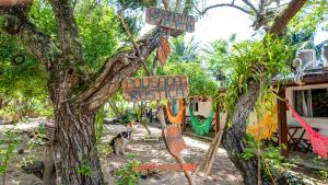 Ein Baum mit Schildern daran neben einem Haus in der Unterkunft Pouso da Pardoca in Santa Cruz + 2 Fotos