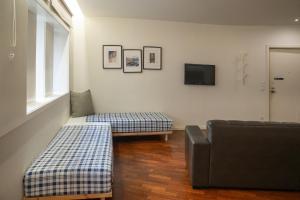 a living room with a couch and a tv at Oporto Riverside Rooftop in Porto