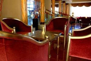 a dining room with red chairs and a table at Cesar Palace Sousse in Sousse