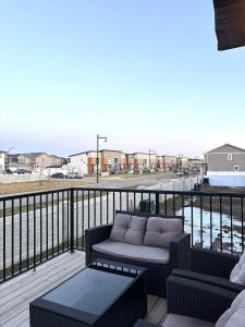 a couch on a balcony with a view of a street at Cozy Heaven in Saskatoon