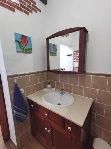 a bathroom with a sink and a mirror at Casa Gloria, encanto canario entre montaña y mar in Arucas +17 photos