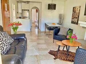 a living room with a couch and a table at Penthouse Apartment Orihuela Costa in Orihuela Costa