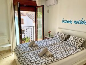 a bedroom with a bed with two pillows on it at Penthouse Apartment Orihuela Costa in Orihuela Costa