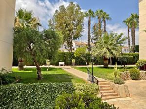 a park with palm trees and a staircase at Penthouse Apartment Orihuela Costa in Orihuela Costa