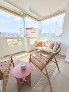 a living room with a couch and chairs and a table at Casa Estío - Renovated 1st line sea view apartment, pool access, AC - Calpe Costa Blanca in Ifach