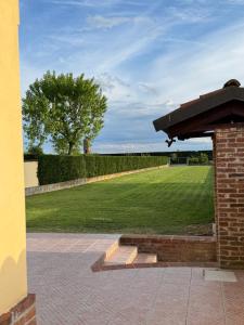 a brick building with a park in the background at Casa Cecilia, Natura & Relax in Villanova dʼAsti