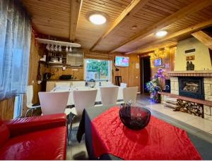 a living room with a table and a fireplace at Anykščių raj. Žalioji Stotelė in Šventupys