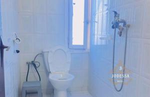 a bathroom with a toilet and a shower with a window at Hôtel Jodesa in Laayoune +25 photos