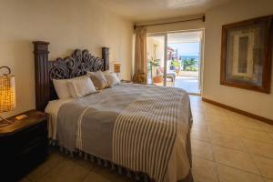 a bedroom with a large bed with a view of the ocean at Oceanview Condo in Faro de Mita in Punta Mita +19 photos