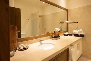 a bathroom with a sink and a large mirror at Oceanview Condo in Faro de Mita in Punta Mita