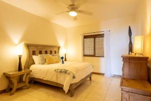 a bedroom with a bed and a ceiling fan at Oceanview Condo in Faro de Mita in Punta Mita