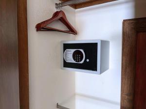 a microwave hanging on a wall in a room at Oceanview Condo in Faro de Mita in Punta Mita