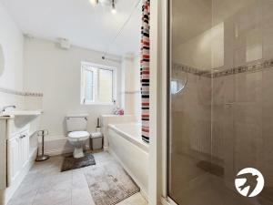 a bathroom with a tub and a toilet and a shower at 6 Bed Longstay & Shortstay property with Wifi & parking sleeps 14 in Chatham +13 photos