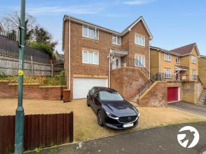 a car parked in front of a brick house at 6 Bed Longstay & Shortstay property with Wifi & parking sleeps 14 in Chatham