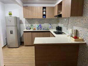 a kitchen with a refrigerator and a counter top at La Casa de Oliva in Norcasia