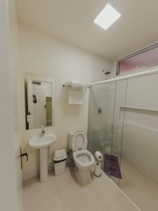 a bathroom with a toilet and a sink and a shower at Recanto das Pedras Lodgin in Santa Maria do Erval +55 photos