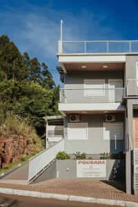 a building with a poolada sign in front of it at Recanto das Pedras Lodgin in Santa Maria do Erval