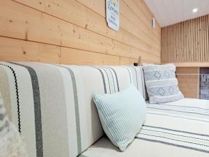 a row of beds in a room with pillows at Tiny House cosy pour une parenthèse nature in Marcilly-sur-Eure +34 photos